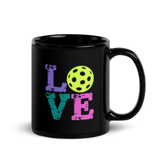 LOVE Pickleball Black Glossy Mug featuring colorful lettering and a yellow pickleball design.