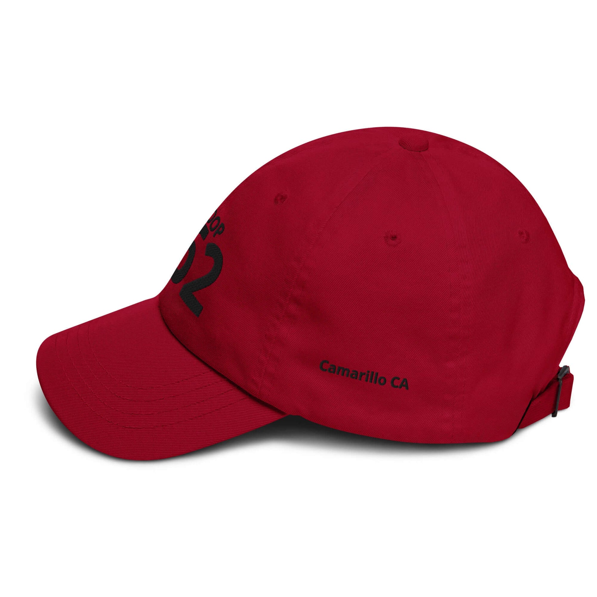 Red low-profile cap with adjustable strap, embroidered number 02, and 'Camarillo CA' detail on the side.