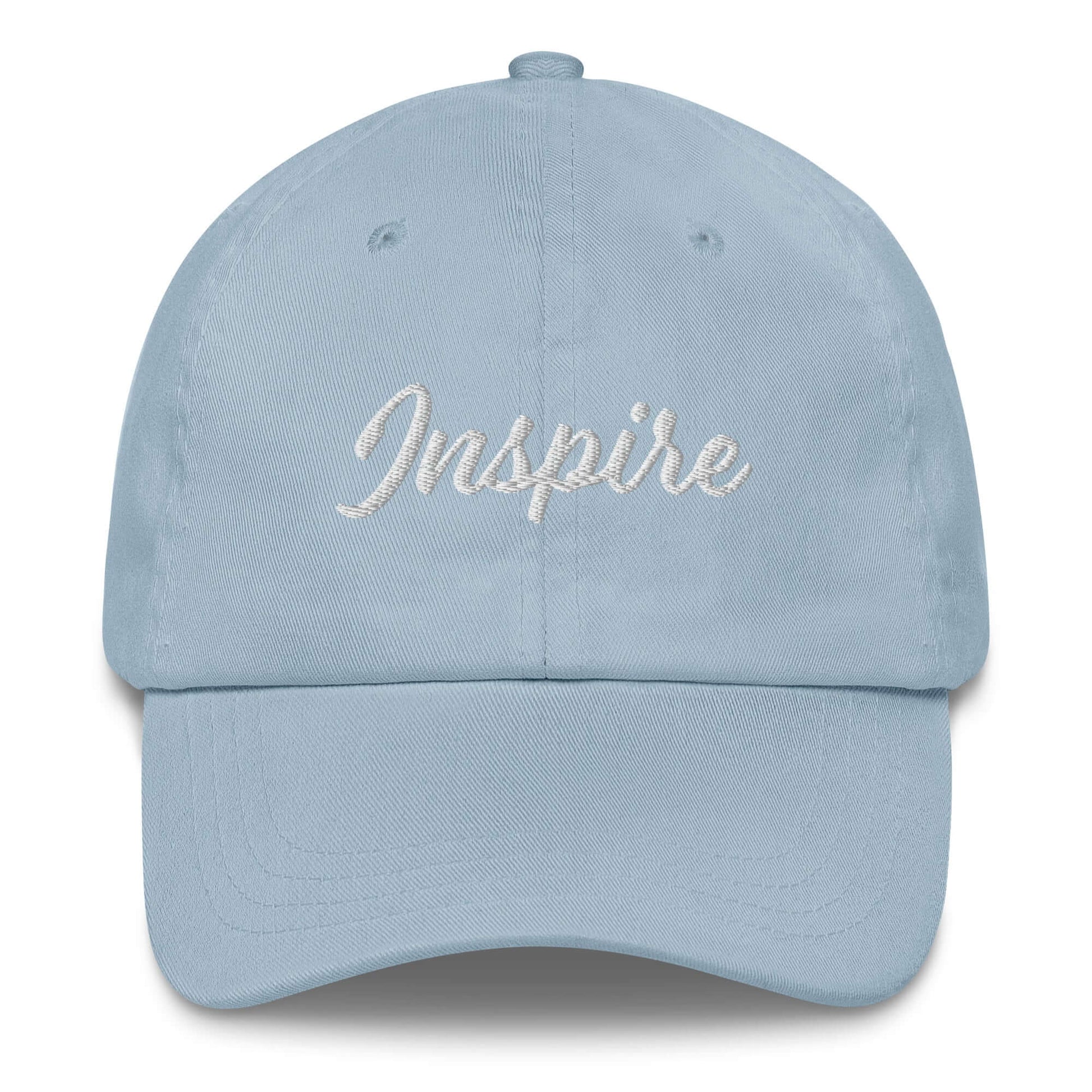 Elegant blue cap with 'Inspire' embroidered in white, a stylish accessory for staying motivated.