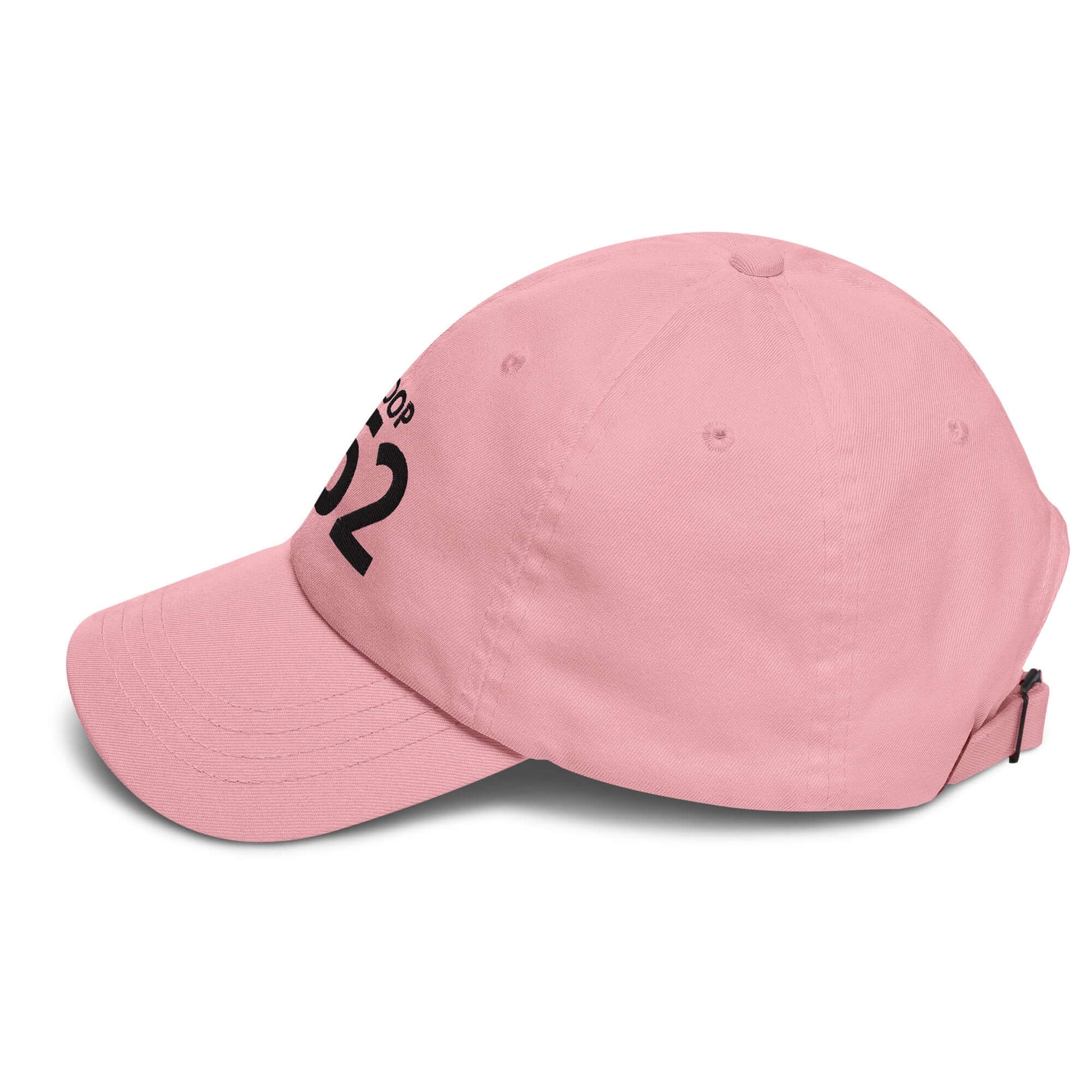 Pink dad hat with adjustable strap and logo, featuring a low profile and curved visor.