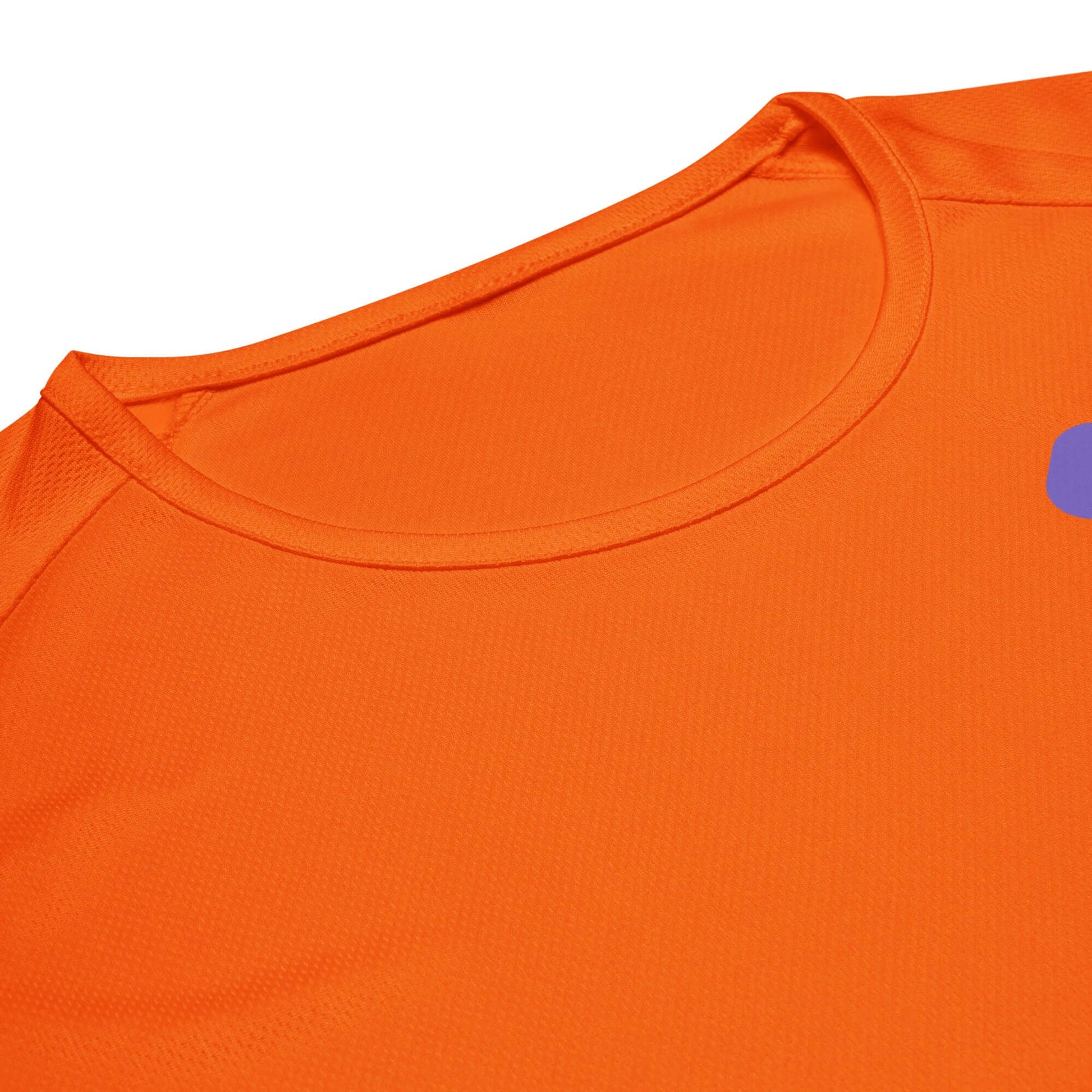 Close-up of the Women’s LOVE Pickleball Performance Shirt in vibrant orange, featuring breathable fabric and a stylish neckline.