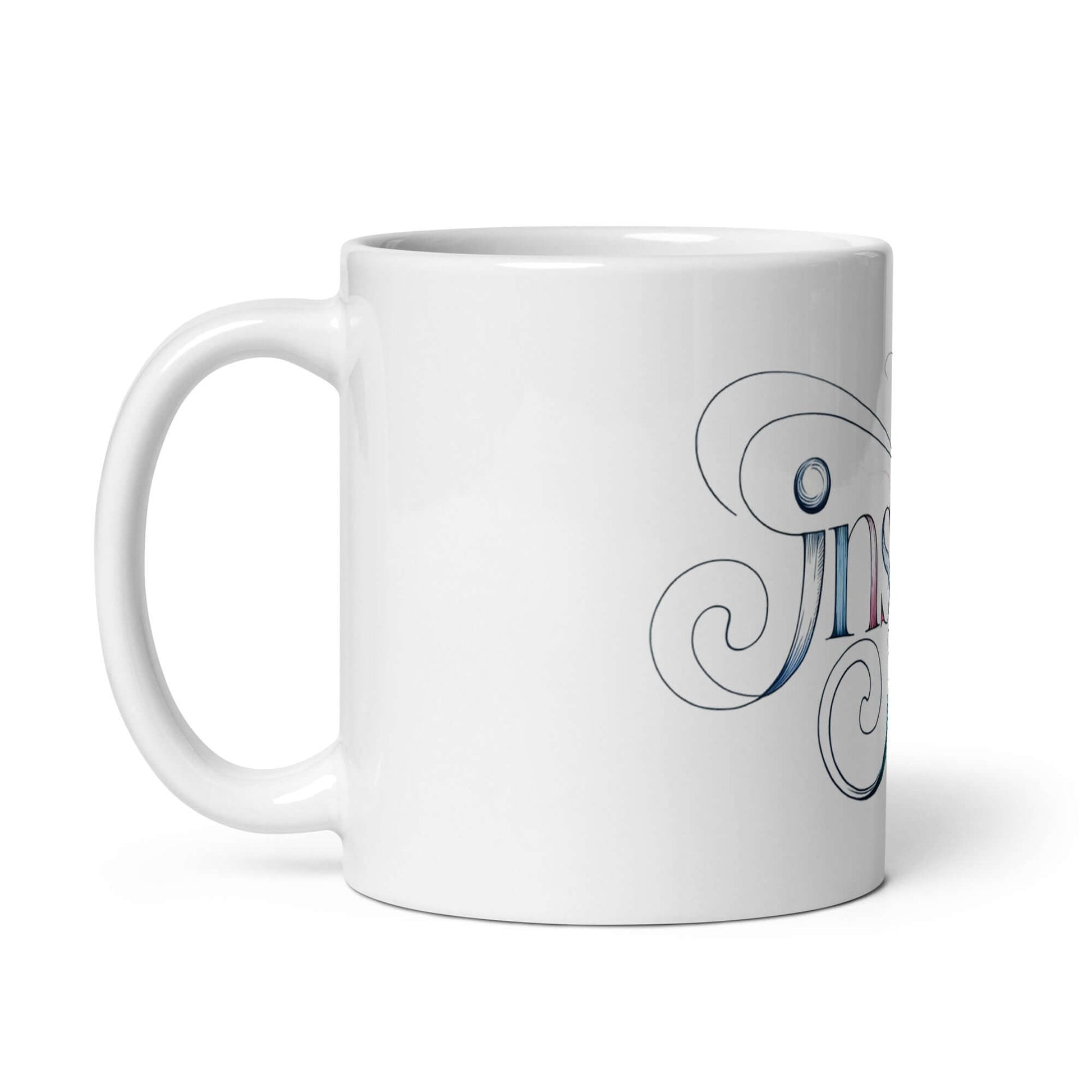 Elegant white glossy mug featuring intricate word art design with the word "Inspire" in graceful letters.