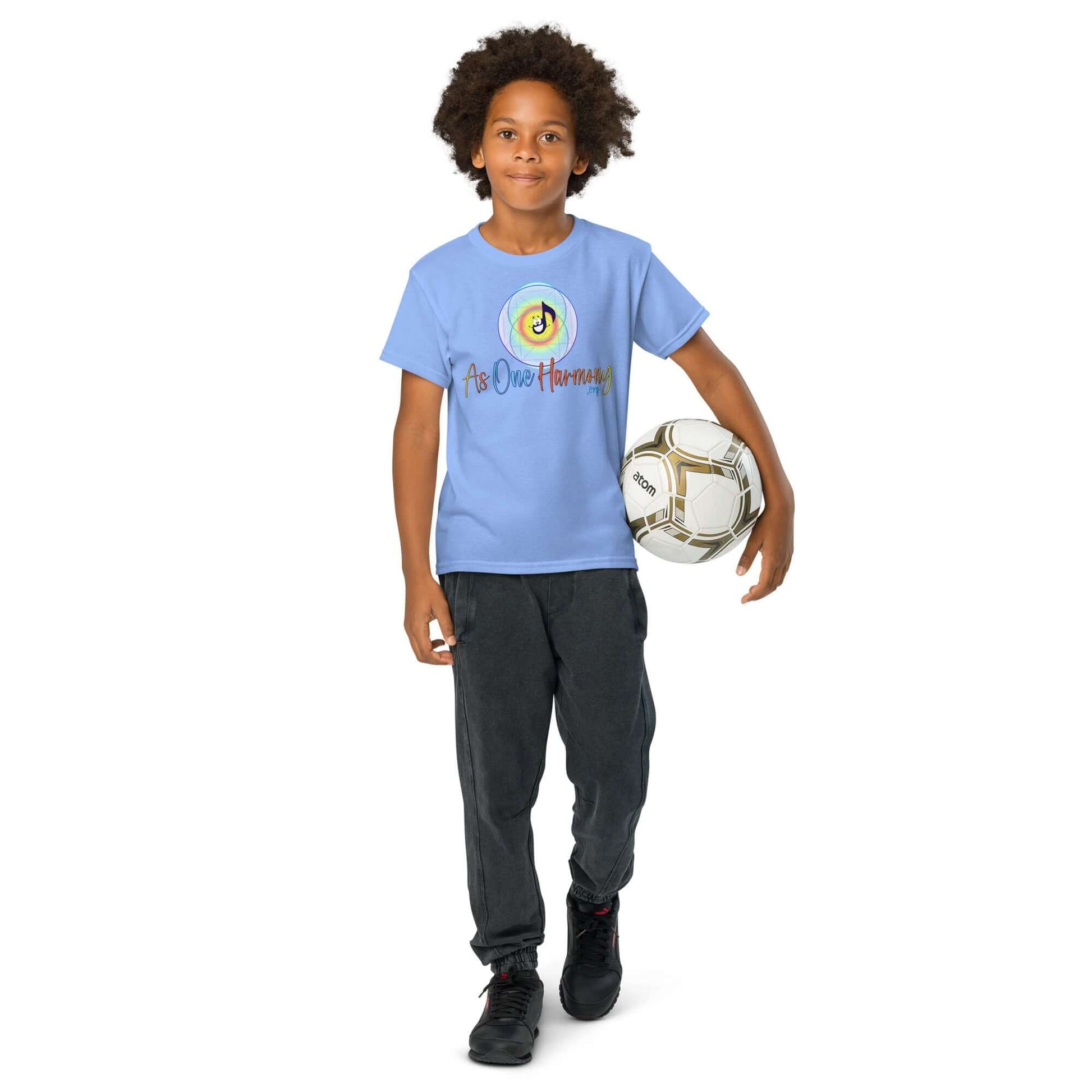 Boy wearing As One Harmony moisture-wicking t-shirt while holding a soccer ball, ideal for active play.