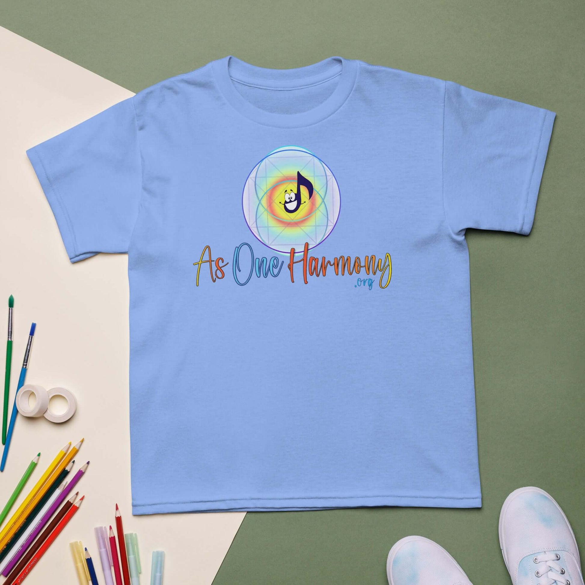 Light blue moisture-wicking t-shirt for kids with 'As One Harmony' design and music note graphic.